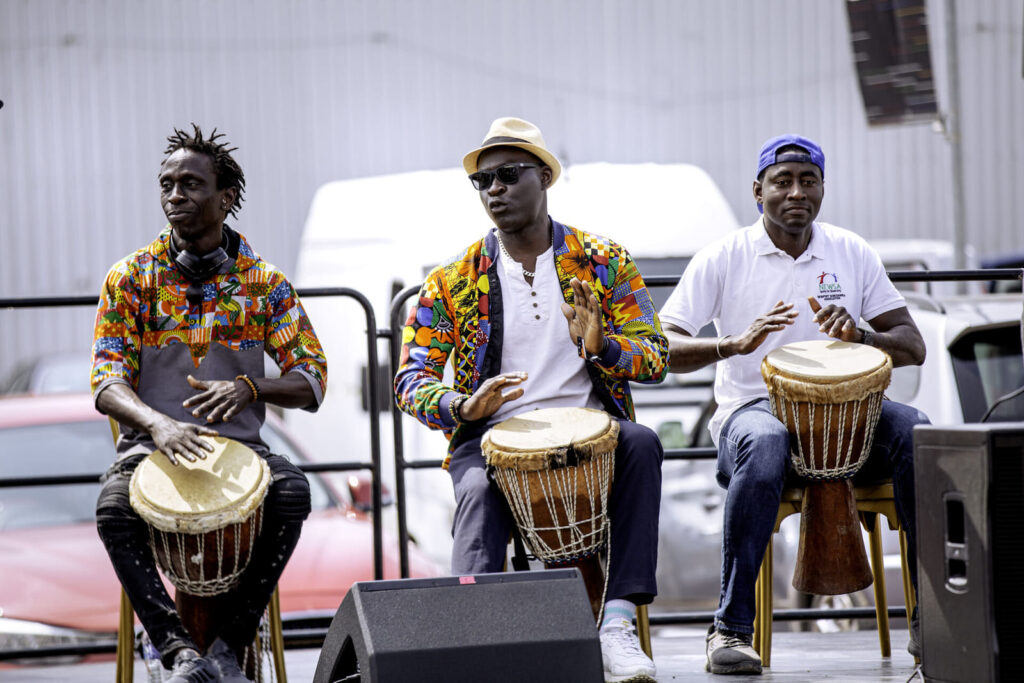 Three drummers performing together at ZNVA's Africa Day event in Newport
