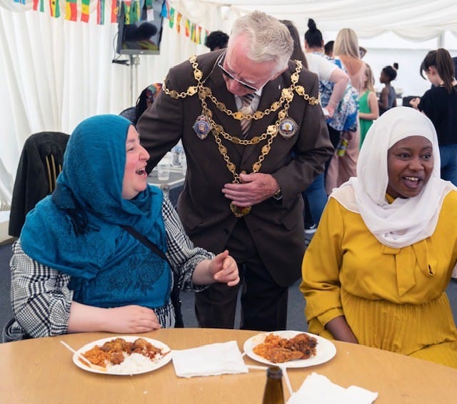 The Mayor of Newport being served food at ZNVA's Africa Day event