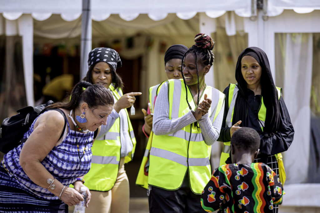 ZNVA volunteers in hi-vis jackets with families at a community fun day