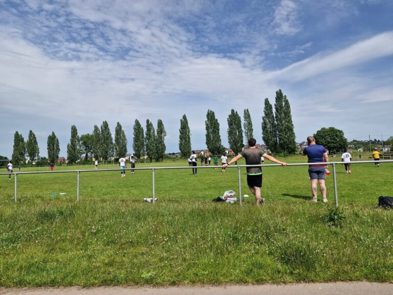 Players and spectators around the football pitch at the ZNVA Refugee Week tournament, Newport, June 2026